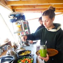 Olivia in a kitchen holding a green drink, used in the 2021 sanctuary post