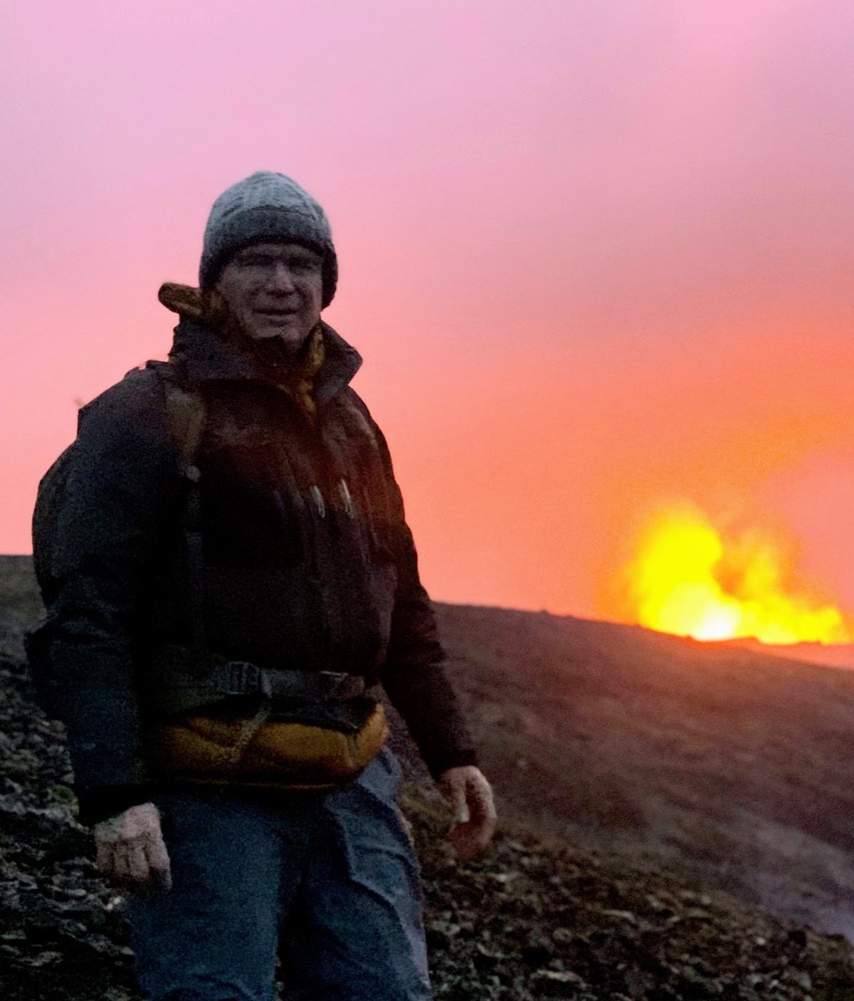 John Hermannsson at night beside the glowing Fagradalsfjall eruption