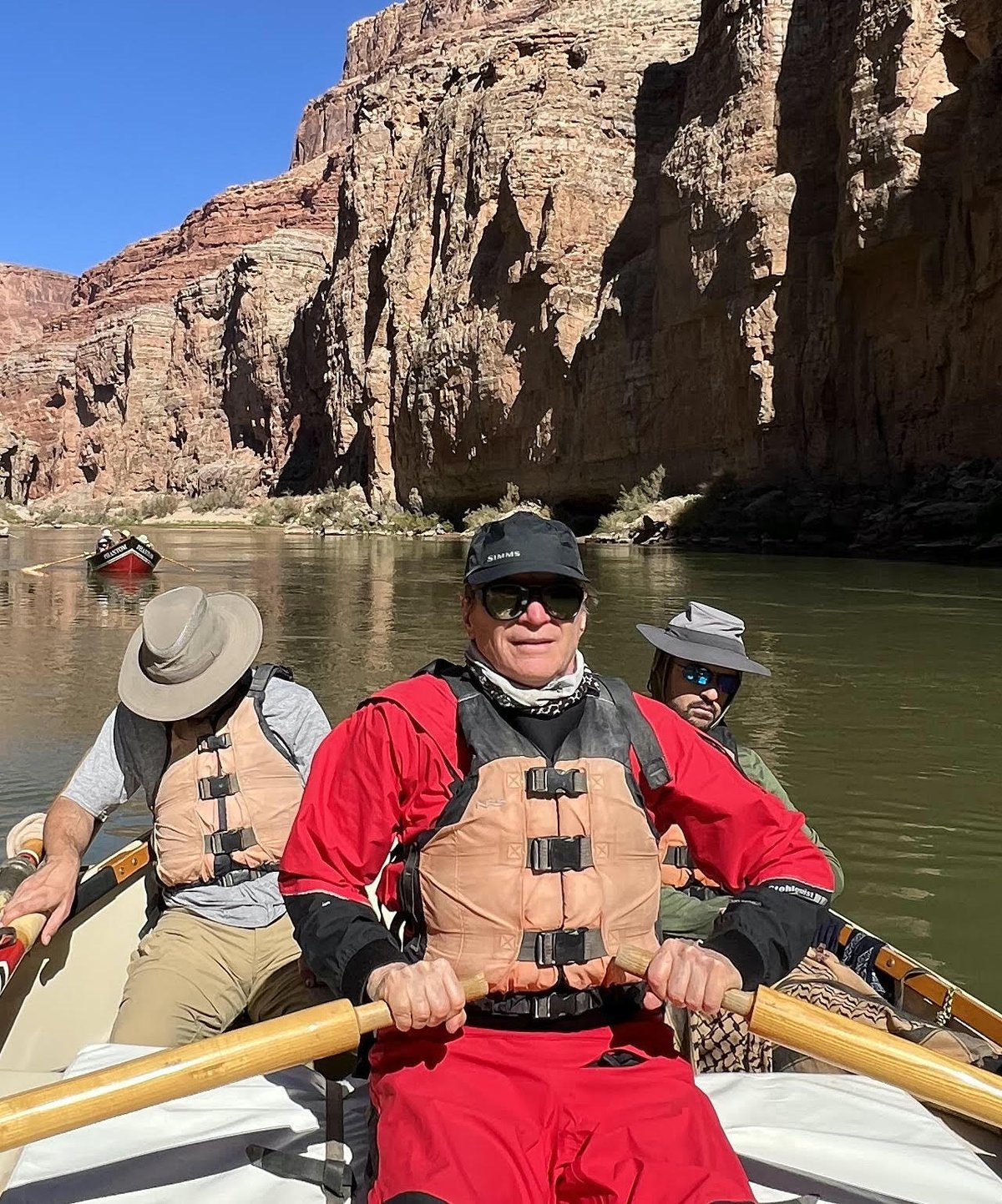John Hermannsson rowing a wooden dory on the Colorado River